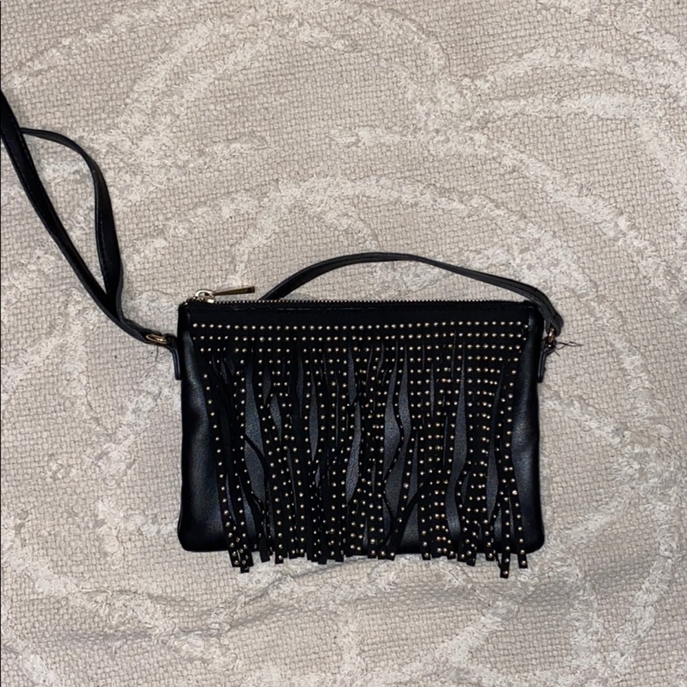 Black purse with tassels with gold detailing.